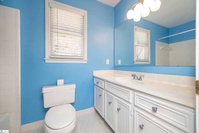 full bath with vanity, tile patterned floors, toilet, and baseboards