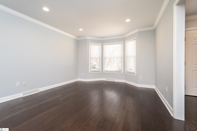 unfurnished room with baseboards, visible vents, dark wood finished floors, recessed lighting, and crown molding