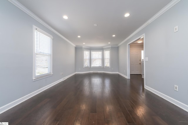 empty room with plenty of natural light, dark wood-style floors, baseboards, and ornamental molding