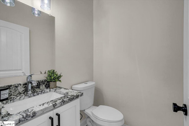 bathroom featuring toilet and vanity