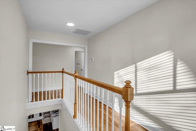 hall featuring visible vents and recessed lighting