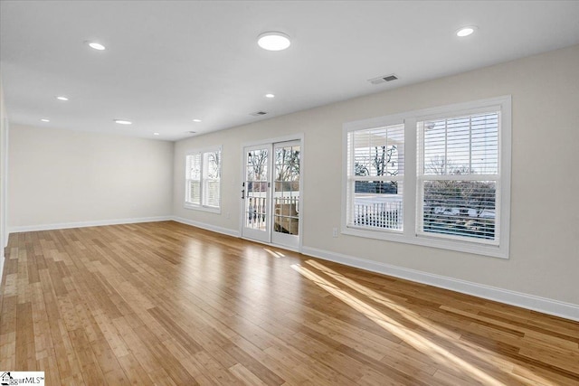 unfurnished room featuring light wood-style flooring, recessed lighting, baseboards, and visible vents