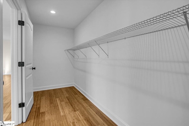 spacious closet with wood finished floors