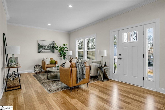 foyer featuring light wood finished floors, recessed lighting, baseboards, and ornamental molding