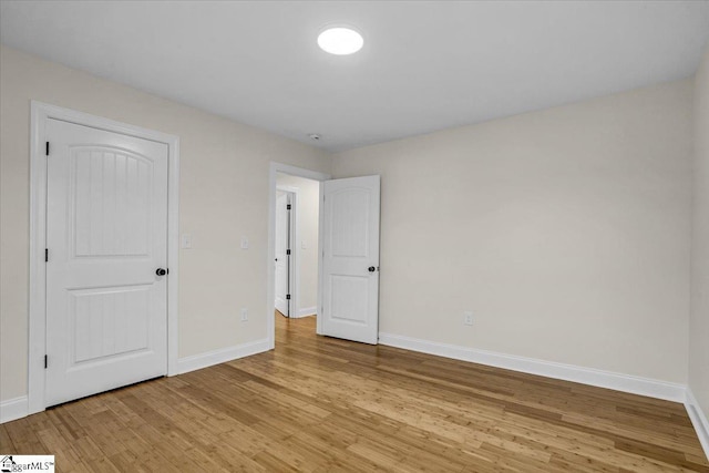 unfurnished bedroom with light wood-style floors and baseboards