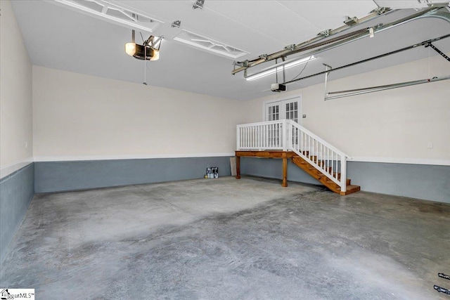 garage featuring french doors and a garage door opener