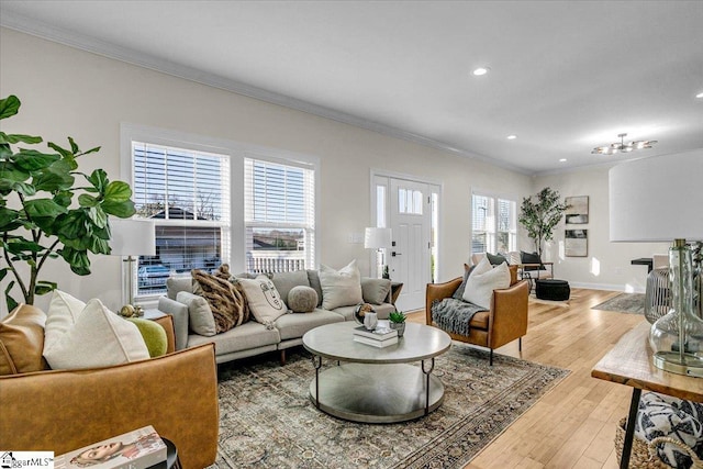 living area with recessed lighting, baseboards, light wood-style floors, and ornamental molding