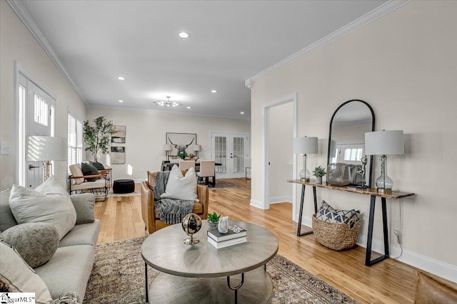 living room with ornamental molding, recessed lighting, french doors, light wood finished floors, and baseboards