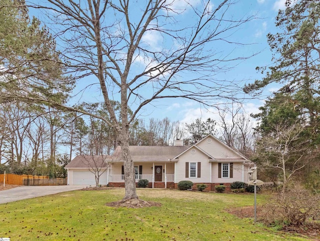 view of front of property with a front yard, fence, covered porch, concrete driveway, and a garage