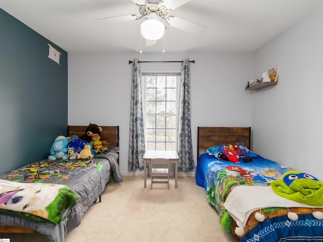 bedroom with a ceiling fan and carpet