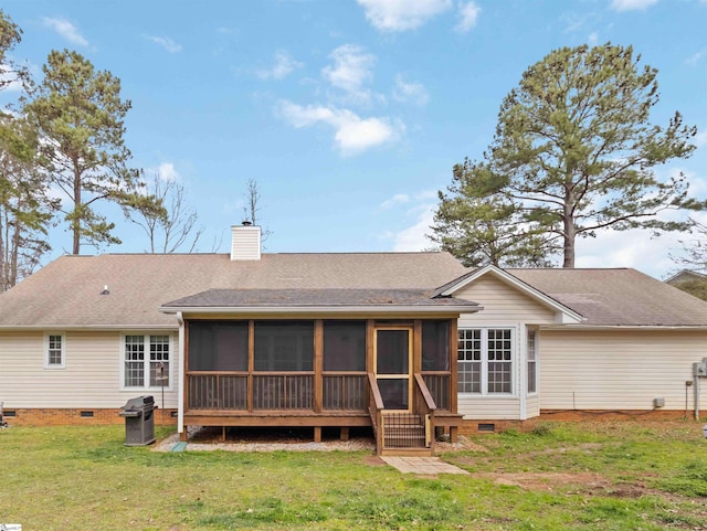 back of property featuring crawl space, a yard, a chimney, and a shingled roof