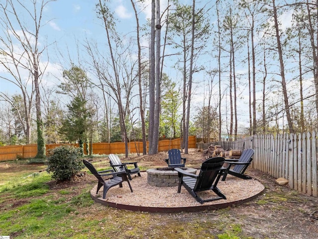 view of yard featuring a fire pit and a fenced backyard