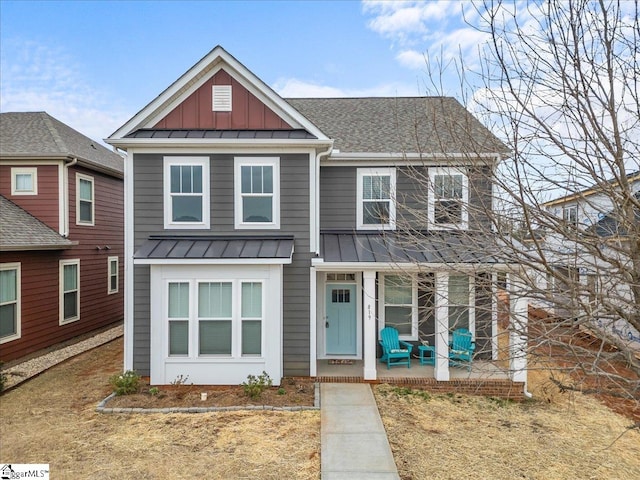 view of front of home with a standing seam roof, a porch, a shingled roof, board and batten siding, and metal roof