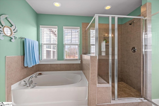 bathroom featuring recessed lighting, a garden tub, and a shower stall