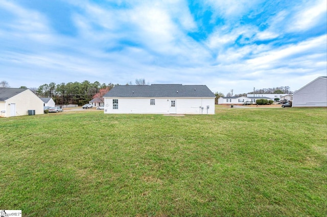 back of property with a lawn