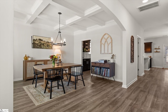 dining area with visible vents, beam ceiling, dark wood finished floors, arched walkways, and baseboards