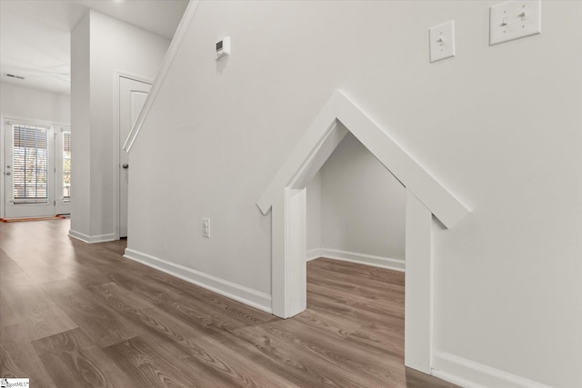 interior space featuring baseboards and wood finished floors