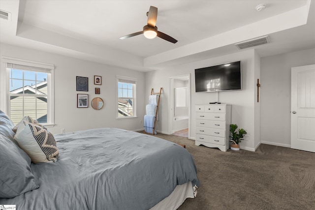 bedroom featuring visible vents, multiple windows, a raised ceiling, and carpet floors