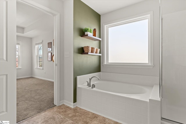 full bathroom with tile patterned floors, baseboards, and a garden tub