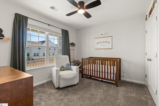 carpeted bedroom featuring visible vents, ceiling fan, baseboards, a closet, and a nursery area