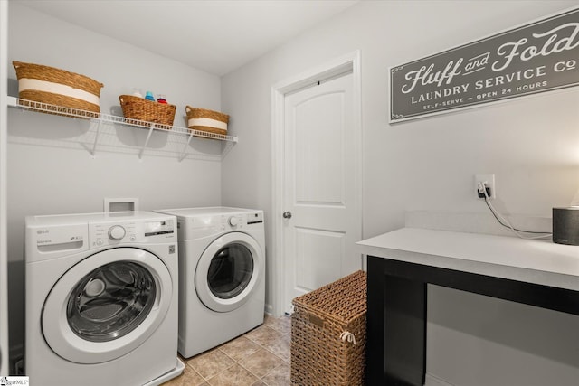 laundry room featuring light tile patterned floors, laundry area, and washing machine and clothes dryer