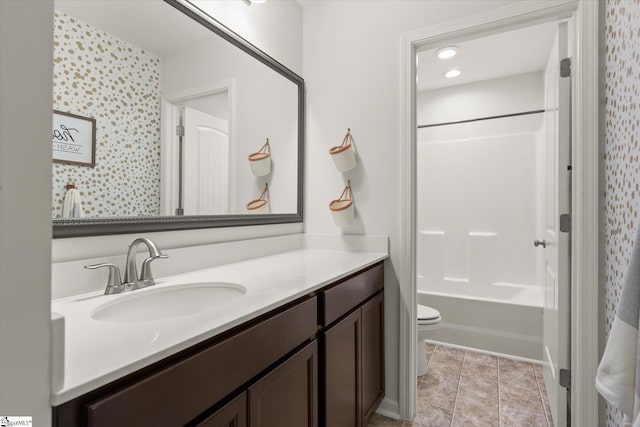 bathroom featuring toilet,  shower combination, vanity, and tile patterned flooring