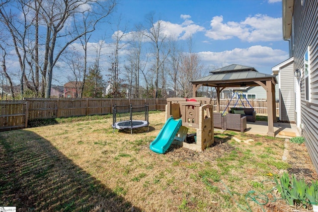 view of yard featuring a fenced backyard, a gazebo, a playground, a trampoline, and a patio area