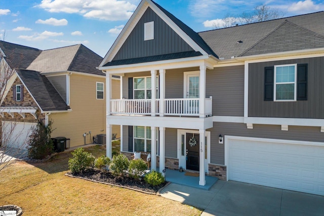 view of front of property featuring board and batten siding, a porch, concrete driveway, central AC, and a front yard