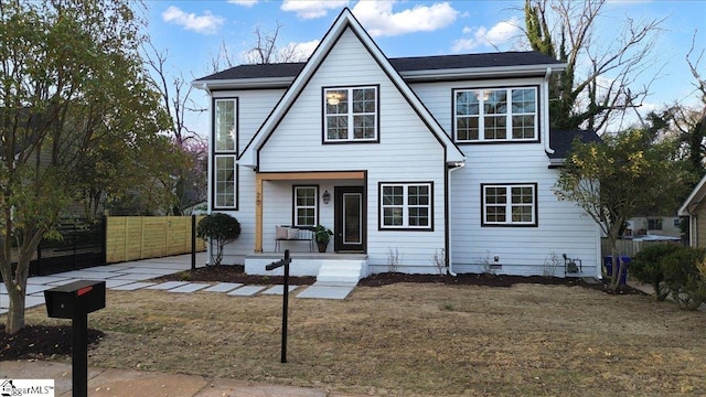 view of front of home featuring fence