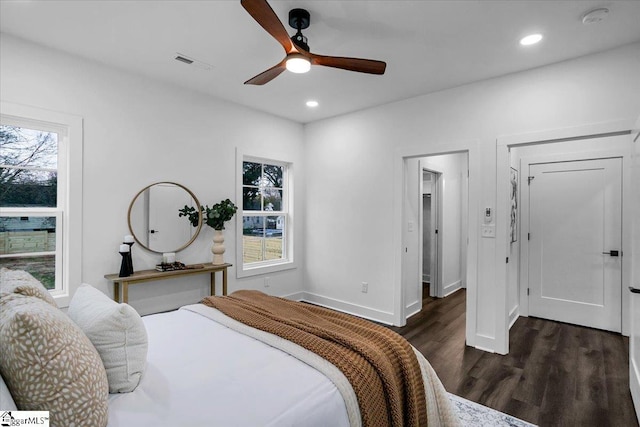 bedroom featuring dark wood-type flooring, multiple windows, recessed lighting, and visible vents