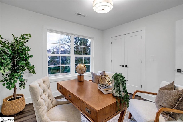 office area with visible vents, baseboards, and wood finished floors