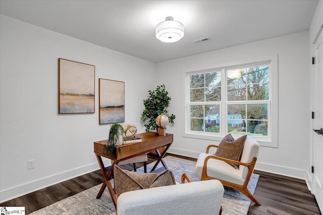 home office featuring visible vents, a healthy amount of sunlight, and dark wood-type flooring