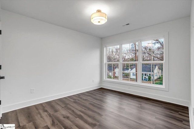 unfurnished room featuring plenty of natural light, baseboards, and visible vents