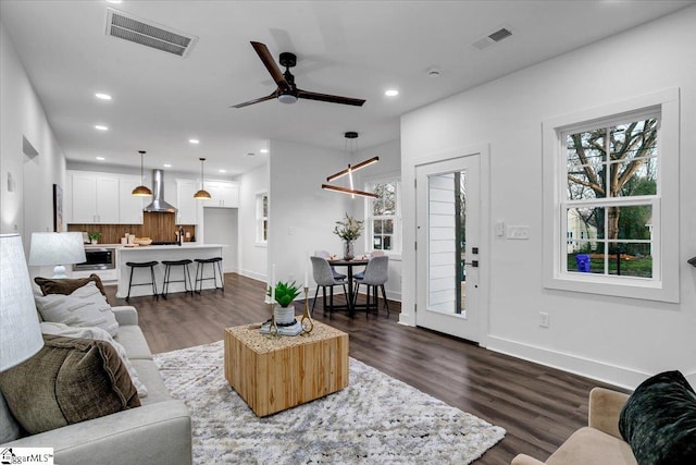 living area featuring recessed lighting, visible vents, and a wealth of natural light