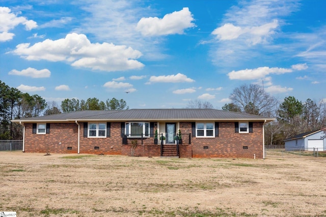 single story home with crawl space, metal roof, brick siding, and fence