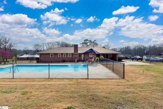 pool featuring a lawn and fence