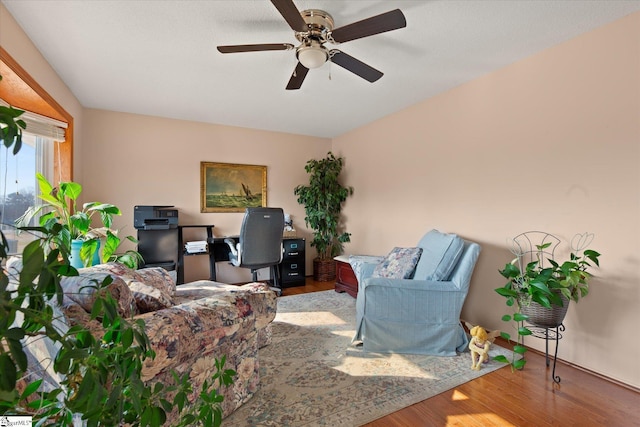 living room featuring wood finished floors and a ceiling fan