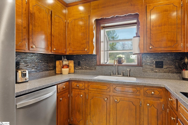 kitchen featuring tasteful backsplash, brown cabinets, dishwasher, and a sink