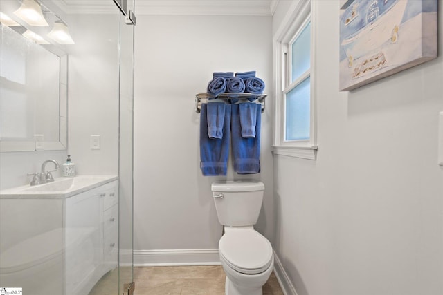 bathroom featuring toilet, vanity, baseboards, and ornamental molding