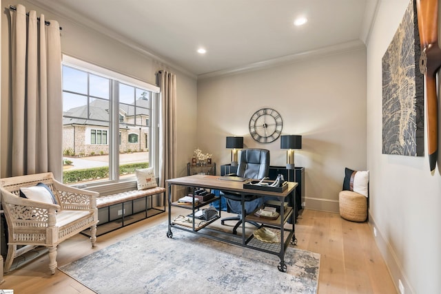 office space with wood finished floors, a healthy amount of sunlight, and ornamental molding