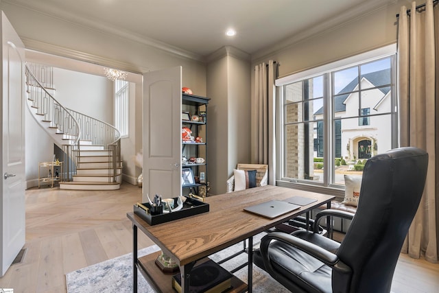 office featuring a wealth of natural light, crown molding, and light wood finished floors