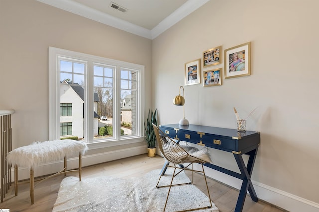 office area featuring visible vents, baseboards, wood finished floors, and ornamental molding