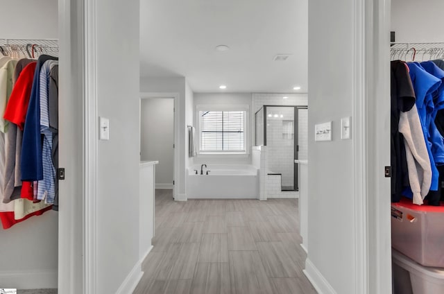 corridor featuring recessed lighting and baseboards