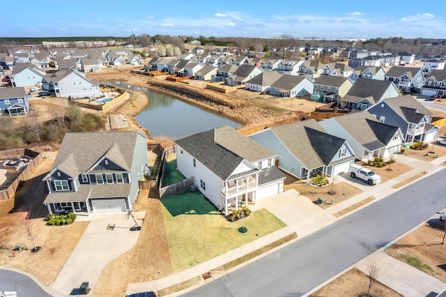 drone / aerial view featuring a residential view and a water view