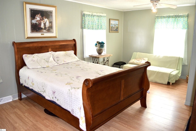 bedroom featuring ornamental molding, baseboards, ceiling fan, and wood finished floors