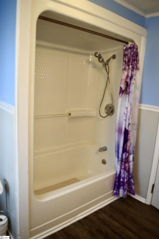 bathroom featuring wood finished floors and shower / bathtub combination