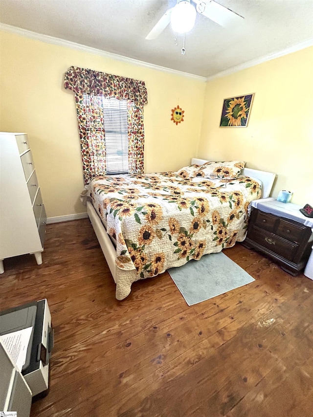 bedroom with ceiling fan, crown molding, baseboards, and hardwood / wood-style flooring