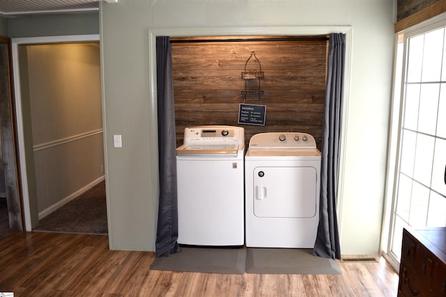 laundry room featuring light wood-style floors, independent washer and dryer, and laundry area