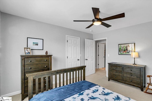 carpeted bedroom featuring a ceiling fan and baseboards