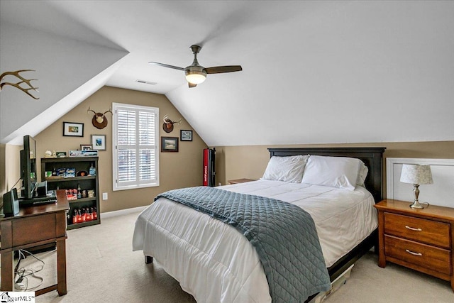 carpeted bedroom featuring lofted ceiling, a ceiling fan, visible vents, and baseboards